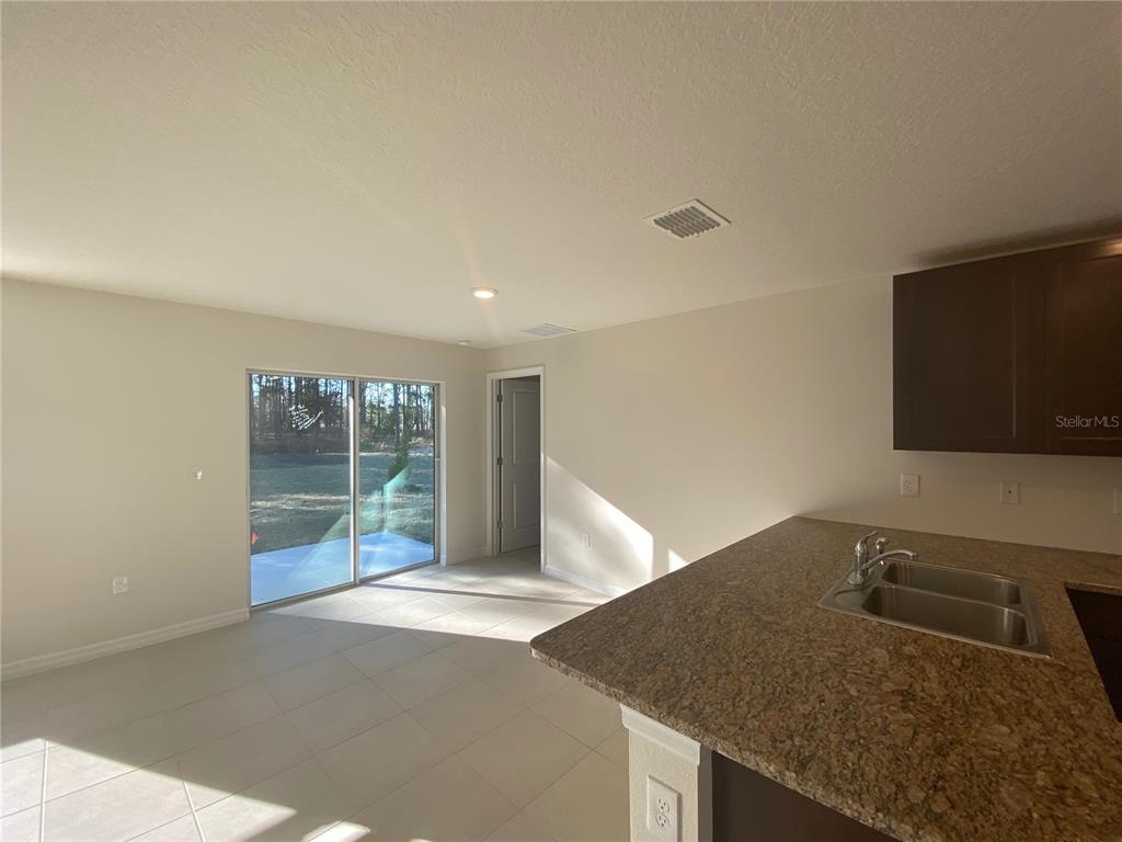 308 Hickory Course Radiel Ocala, FL 34472 - Photo 8 of 24 a kitchen with a granite countertop sink and natural light