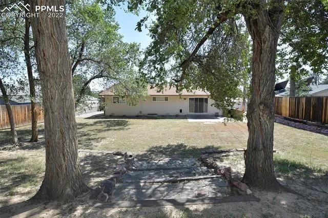 a view of a house with a tree in the background