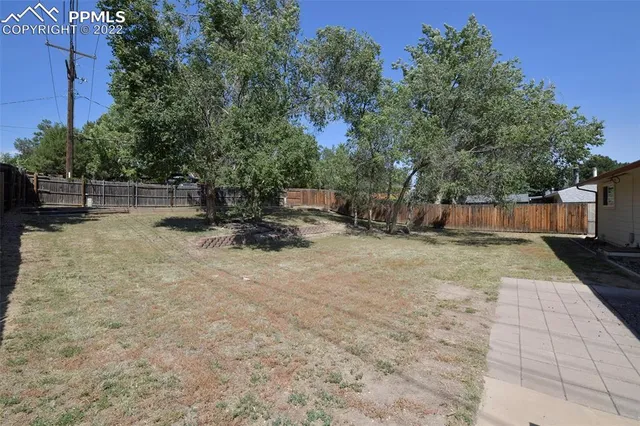 a view of a backyard with a bench
