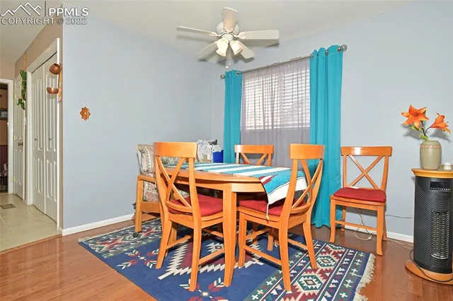 a dining room table chairs and chandelier