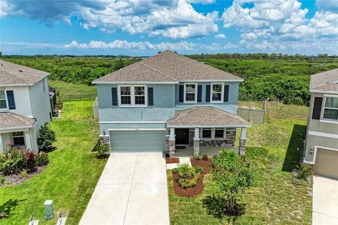 a front view of a house with yard patio and green space