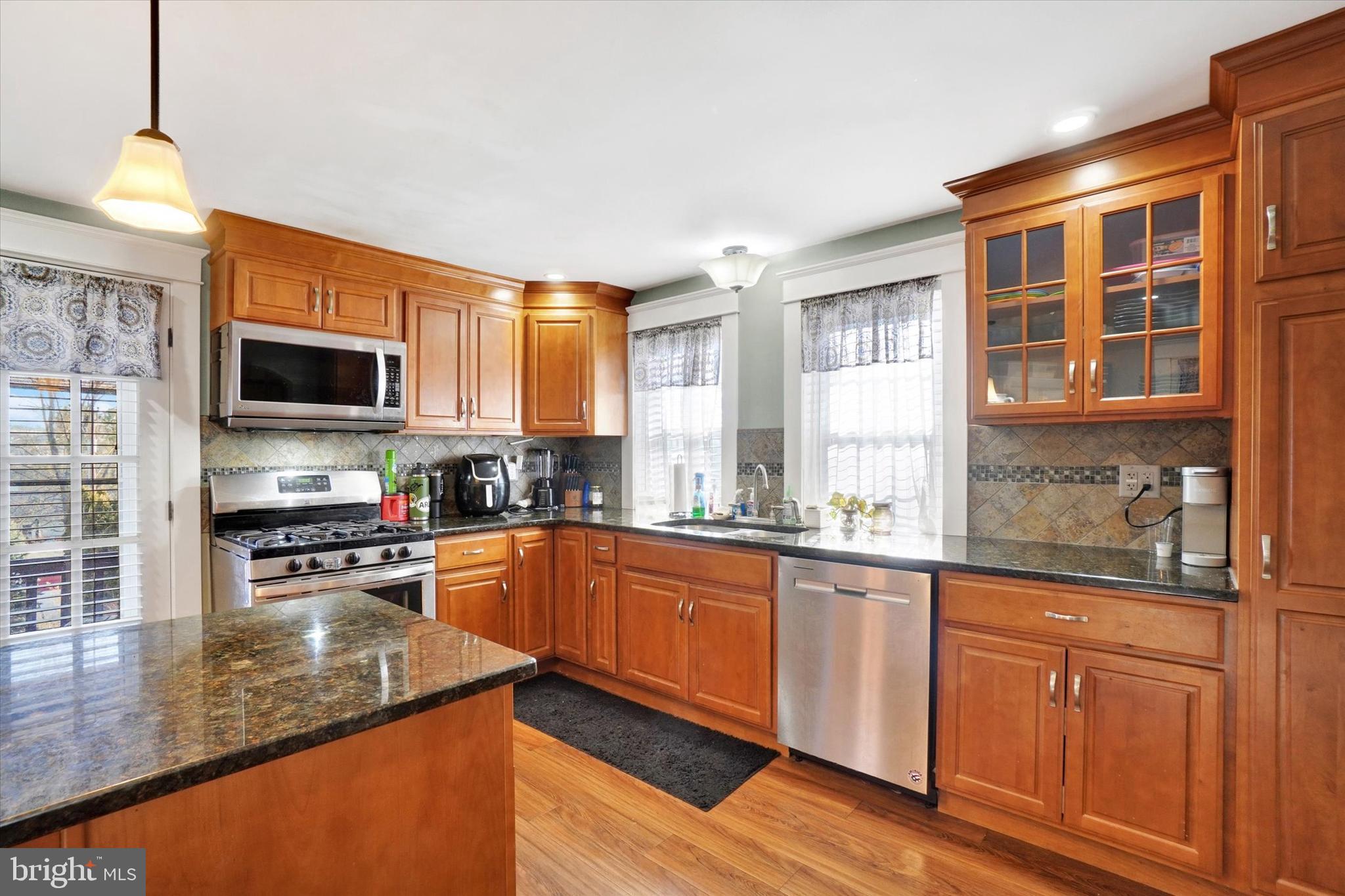 370 East Market Street York, PA 17406 - Photo 11 of 27 a kitchen with stainless steel appliances granite countertop wooden cabinets a stove top oven a sink and dishwasher with wooden floor