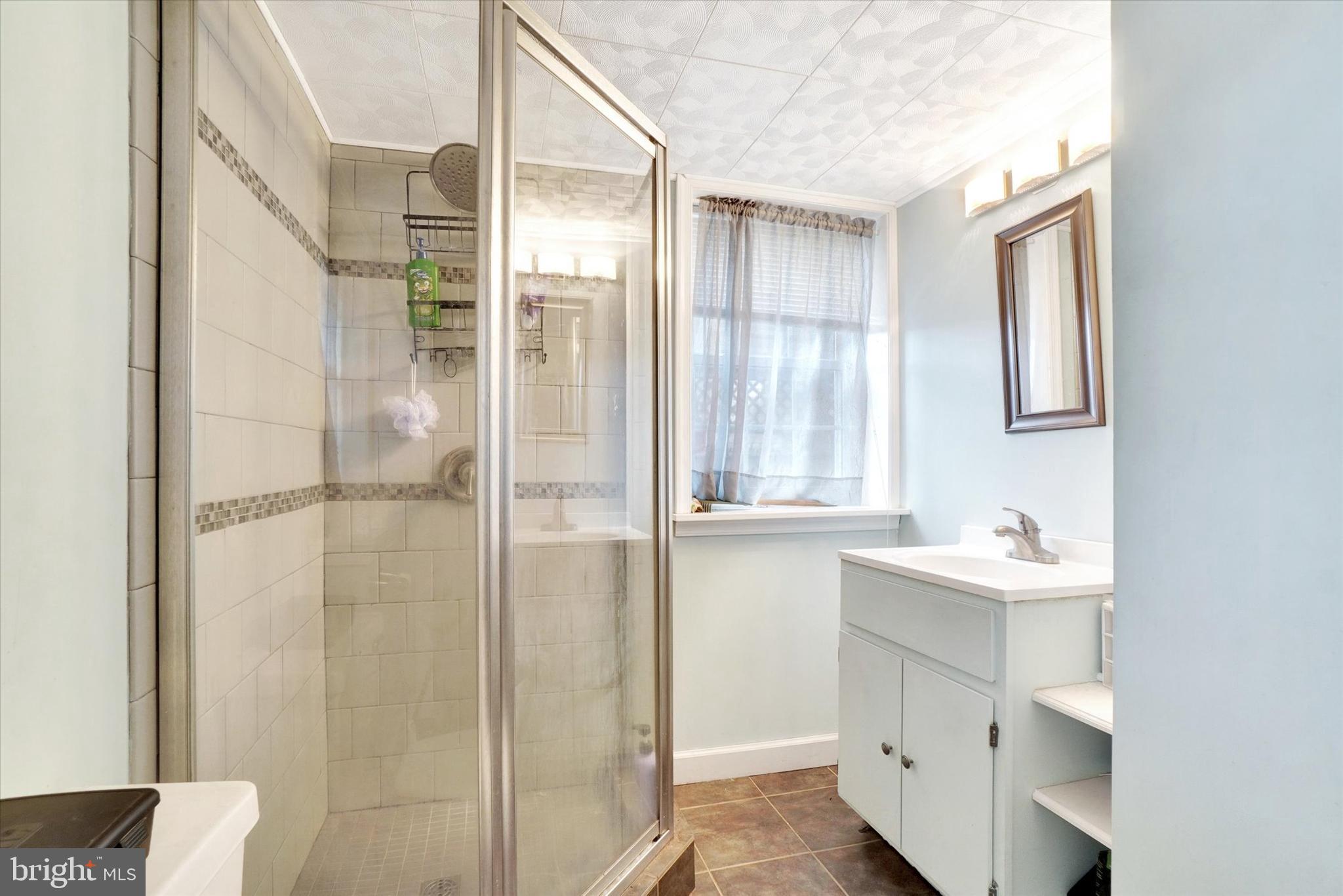 370 East Market Street York, PA 17406 - Photo 18 of 27 a bathroom with a sink mirror and shower