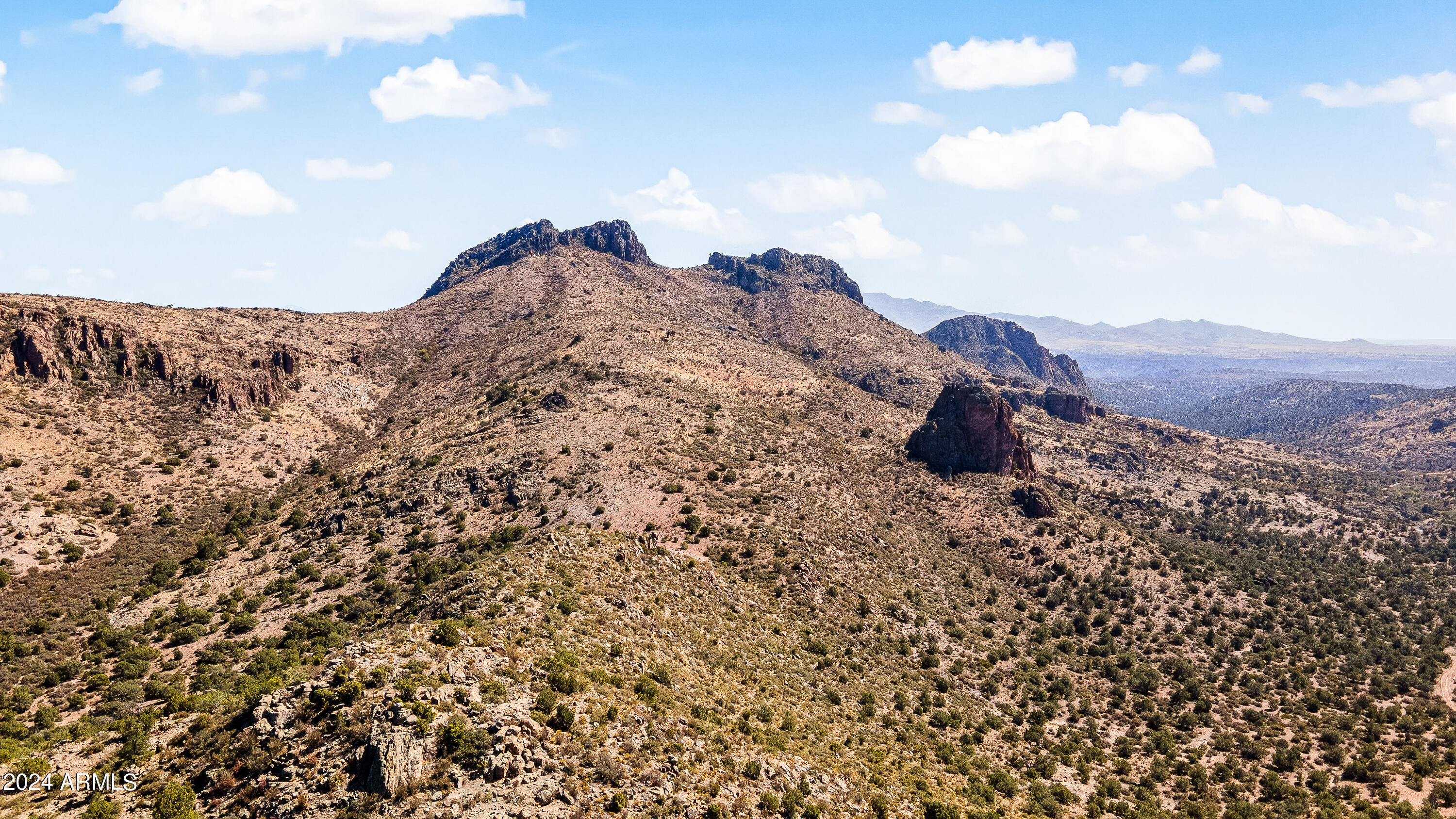 4820 East Perkinsville Road Chino Valley, AZ 86323 - Photo 103 of 128 a view of a dry field with mountains in the background