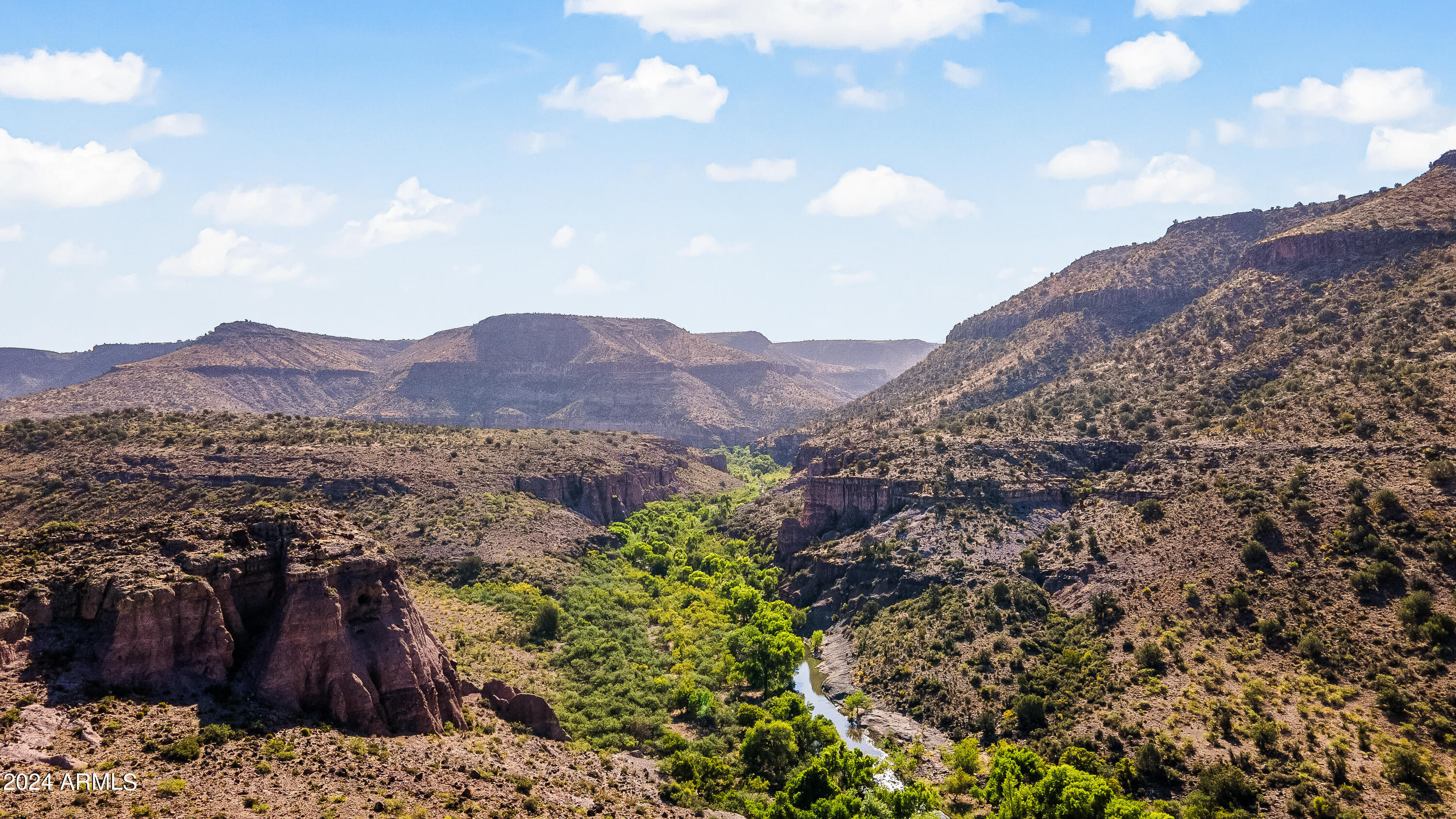 4820 East Perkinsville Road Chino Valley, AZ 86323 - Photo 125 of 128 a view of a lush green field with mountains in the background