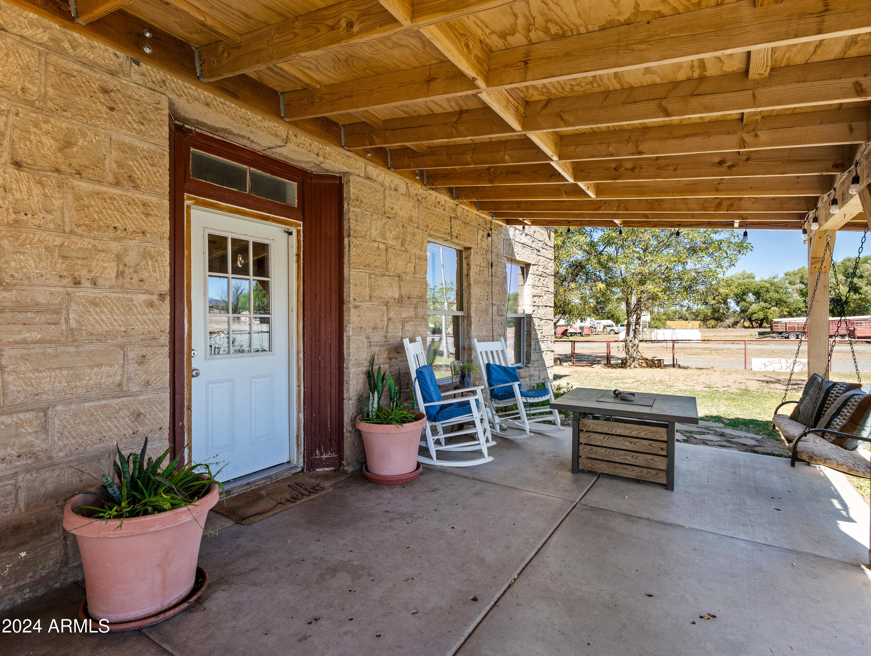 4820 East Perkinsville Road Chino Valley, AZ 86323 - Photo 49 of 128 a view of a patio with table and chairs potted plants