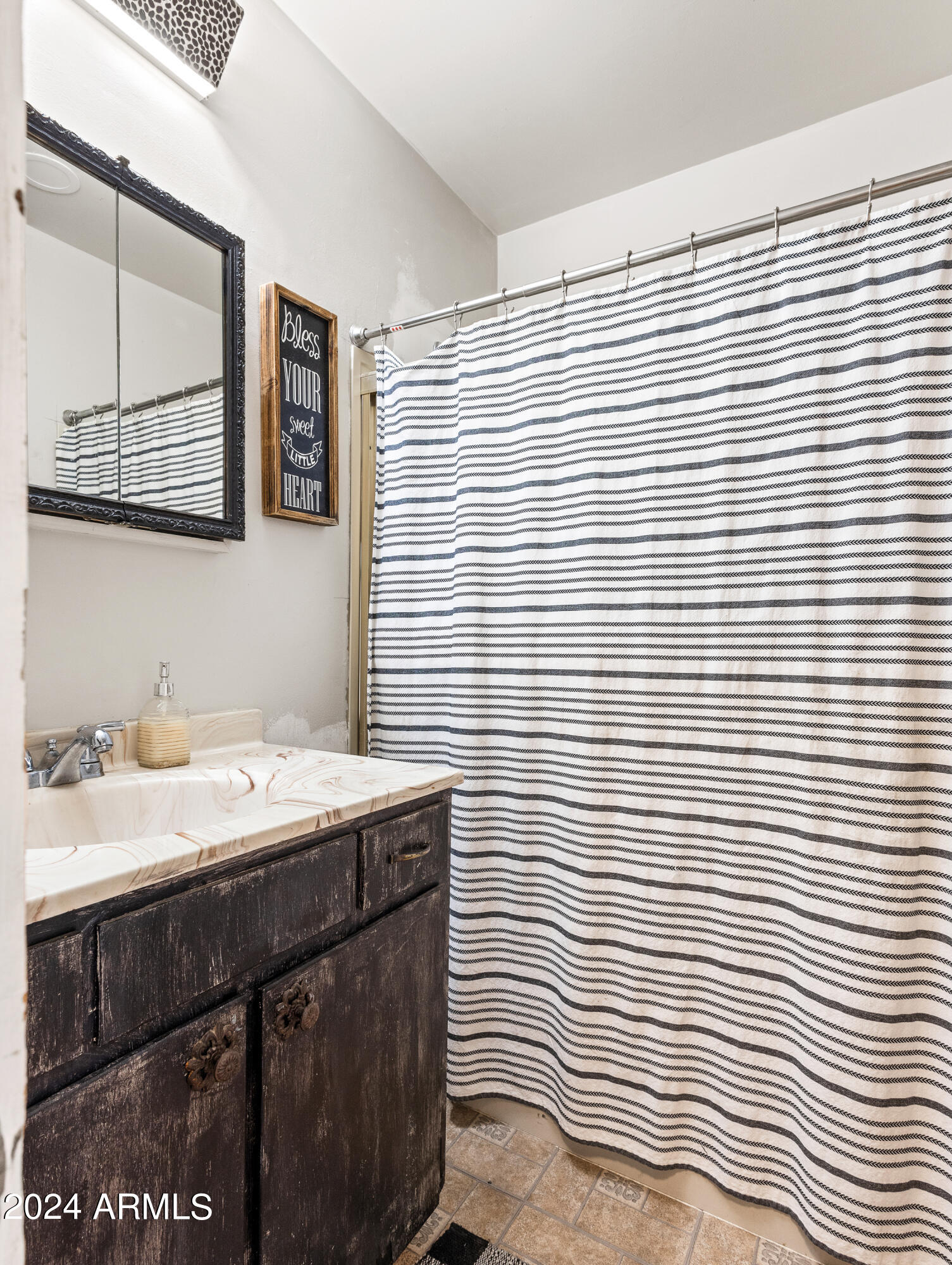 4820 East Perkinsville Road Chino Valley, AZ 86323 - Photo 60 of 128 a bathroom with a sink a mirror and shower curtain