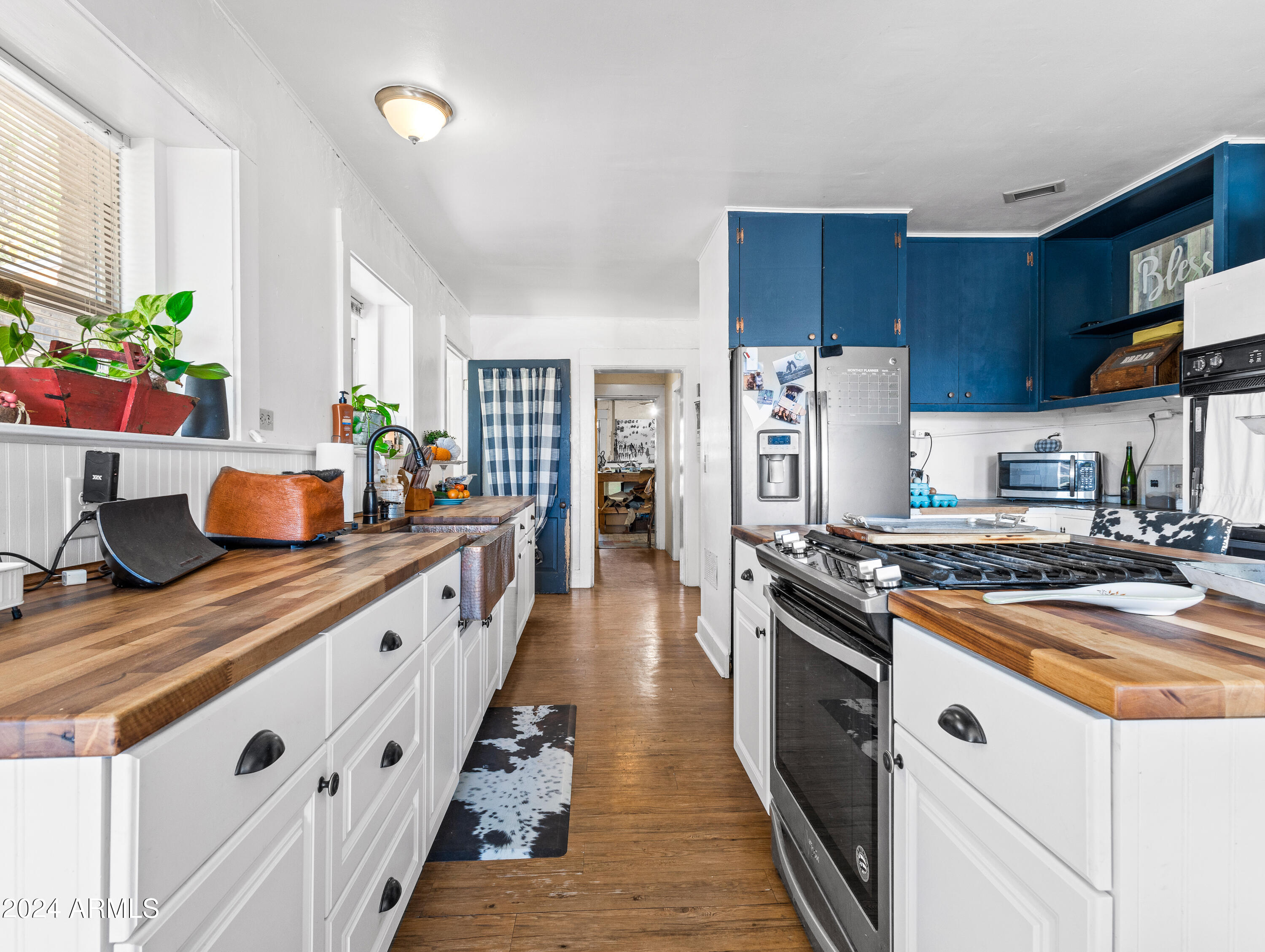 4820 East Perkinsville Road Chino Valley, AZ 86323 - Photo 63 of 128 a kitchen with stainless steel appliances a sink stove and cabinets