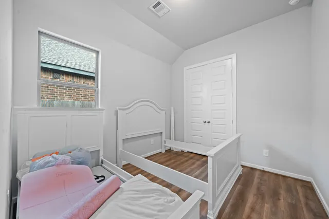 a view of an empty room and wooden floor