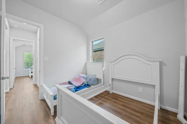 a view of a room with wooden floor and furniture