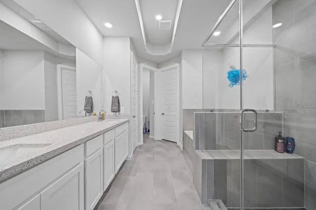 a bathroom with a double vanity sink and a mirror