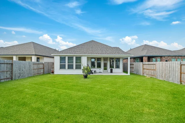 a view of a house with a backyard