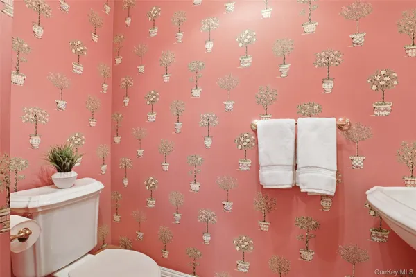 a bathroom with a toilet sink and mirror