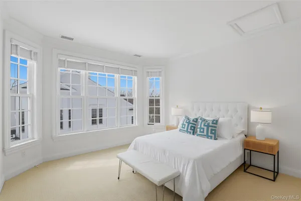 a bedroom with a bed and a large window
