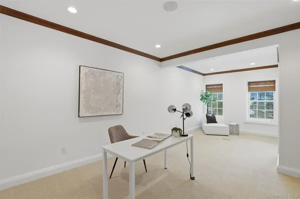 a living room with furniture a window and a potted plant