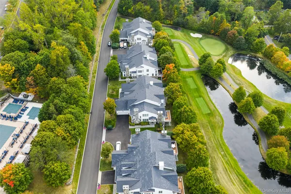 an aerial view of residential houses with outdoor space and street view