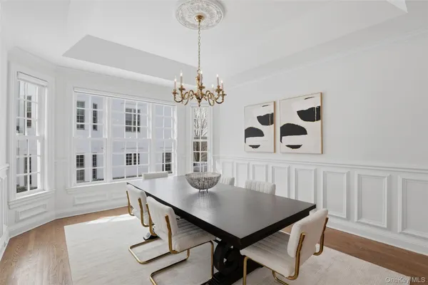 a view of a dining room with furniture and a chandelier