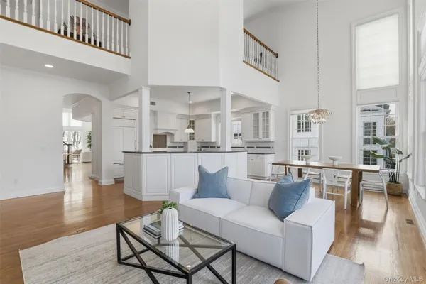 a living room with furniture wooden floor and a large window