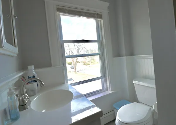 a white toilet sitting next to a bathroom sink