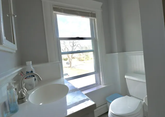 a white toilet sitting next to a bathroom sink