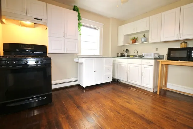a kitchen with wooden floors and appliances