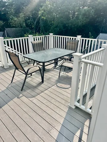 a view of balcony with wooden floor and outdoor seating