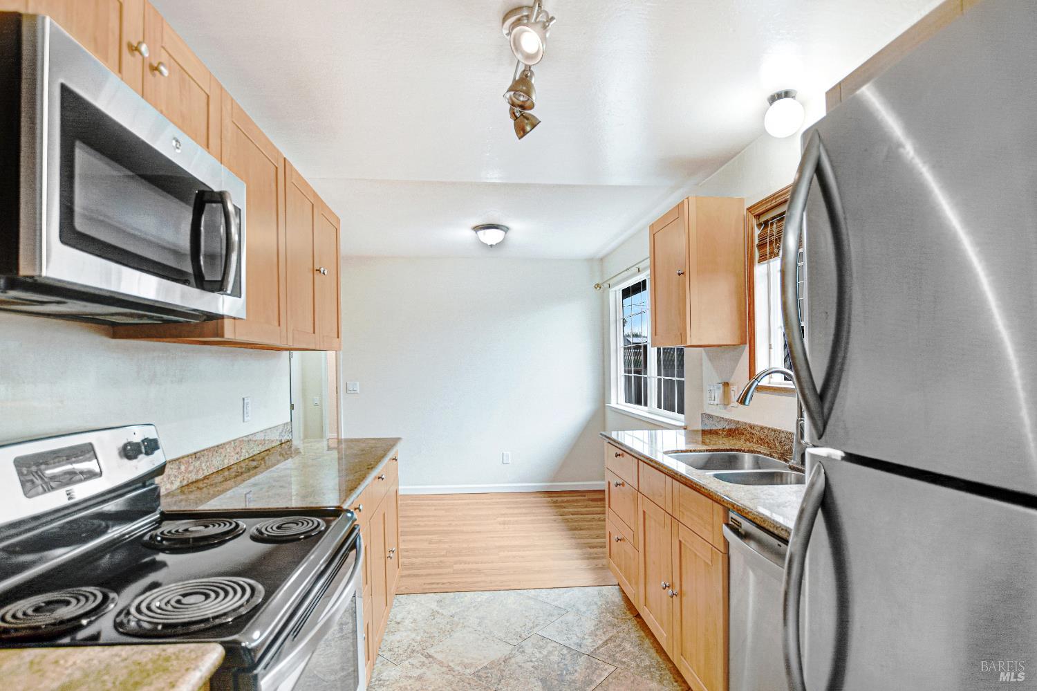 7257 Belita Avenue Rohnert Park, CA 94928 - Photo 13 of 37 a kitchen with stainless steel appliances granite countertop a stove a sink and a refrigerator