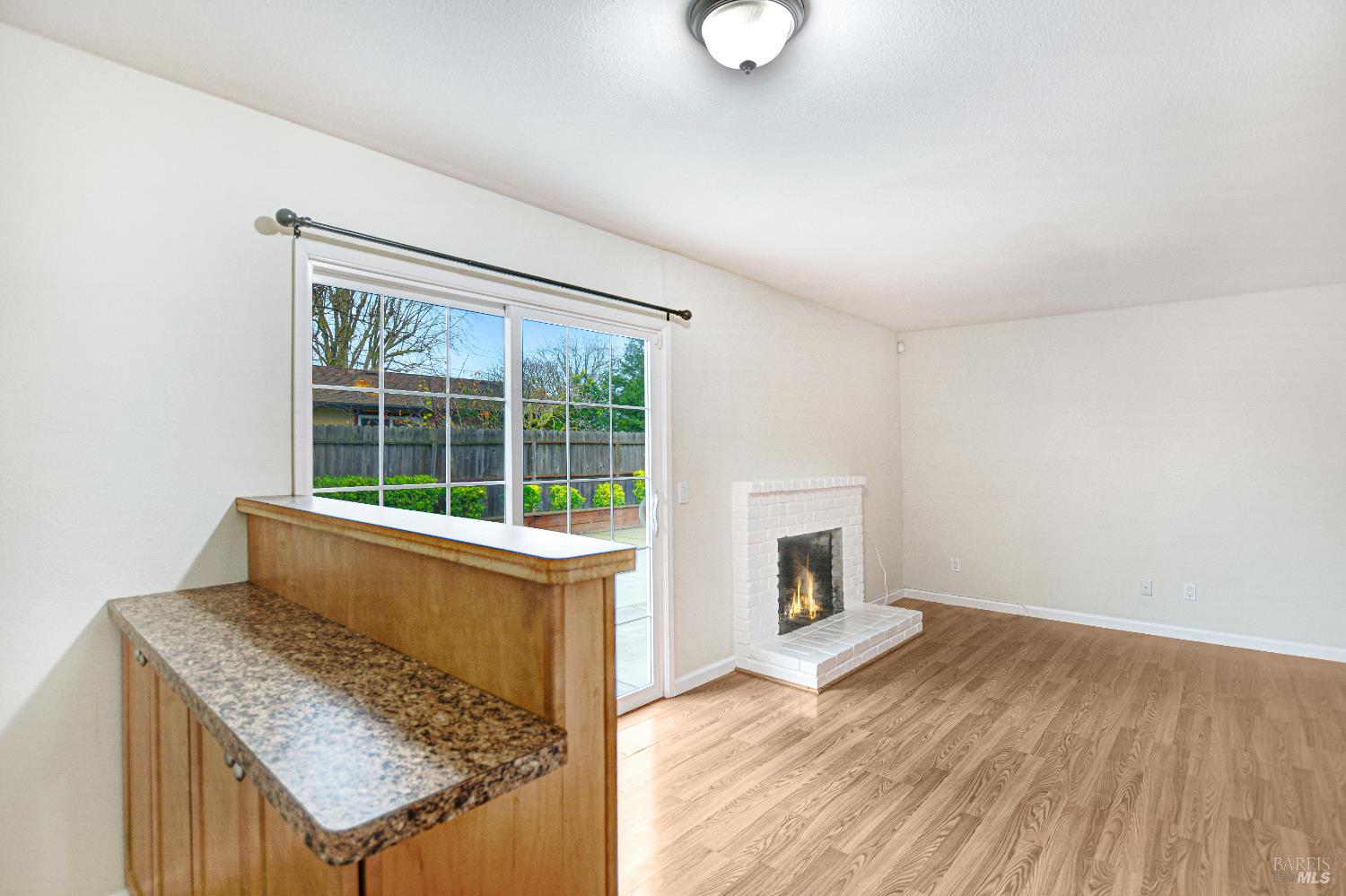 7257 Belita Avenue Rohnert Park, CA 94928 - Photo 15 of 37 a room with wooden floor and a fireplace