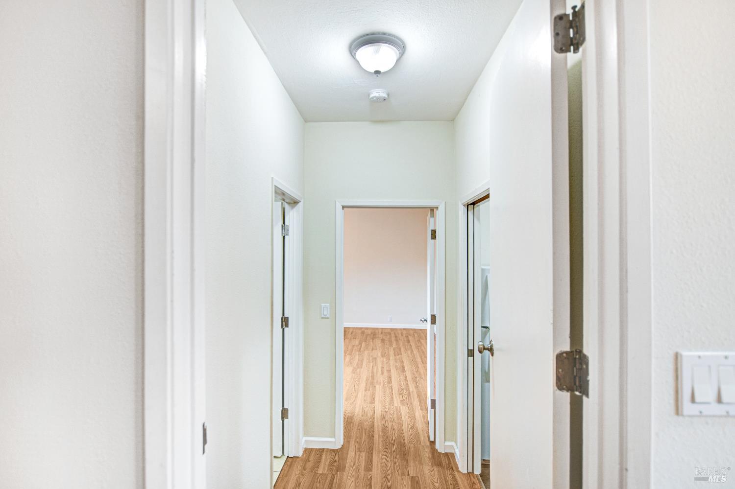 7257 Belita Avenue Rohnert Park, CA 94928 - Photo 18 of 37 a view of a hallway with wooden floor and entryway