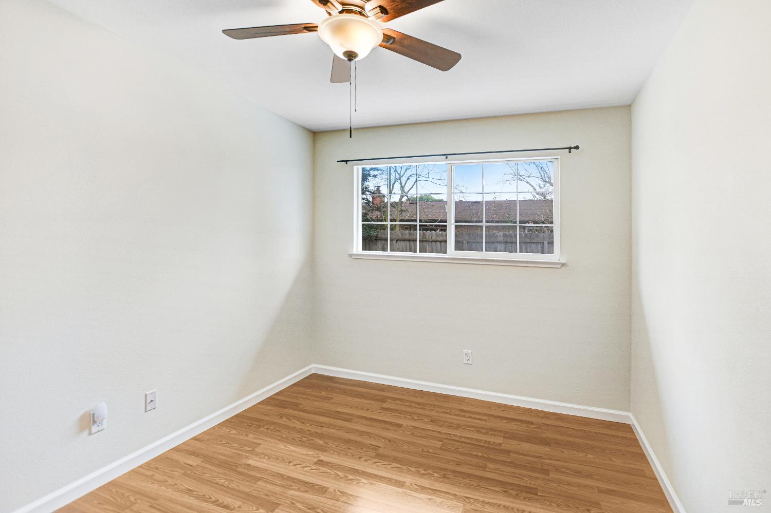 7257 Belita Avenue Rohnert Park, CA 94928 - Photo 27 of 37 an empty room with wooden floor fan and windows