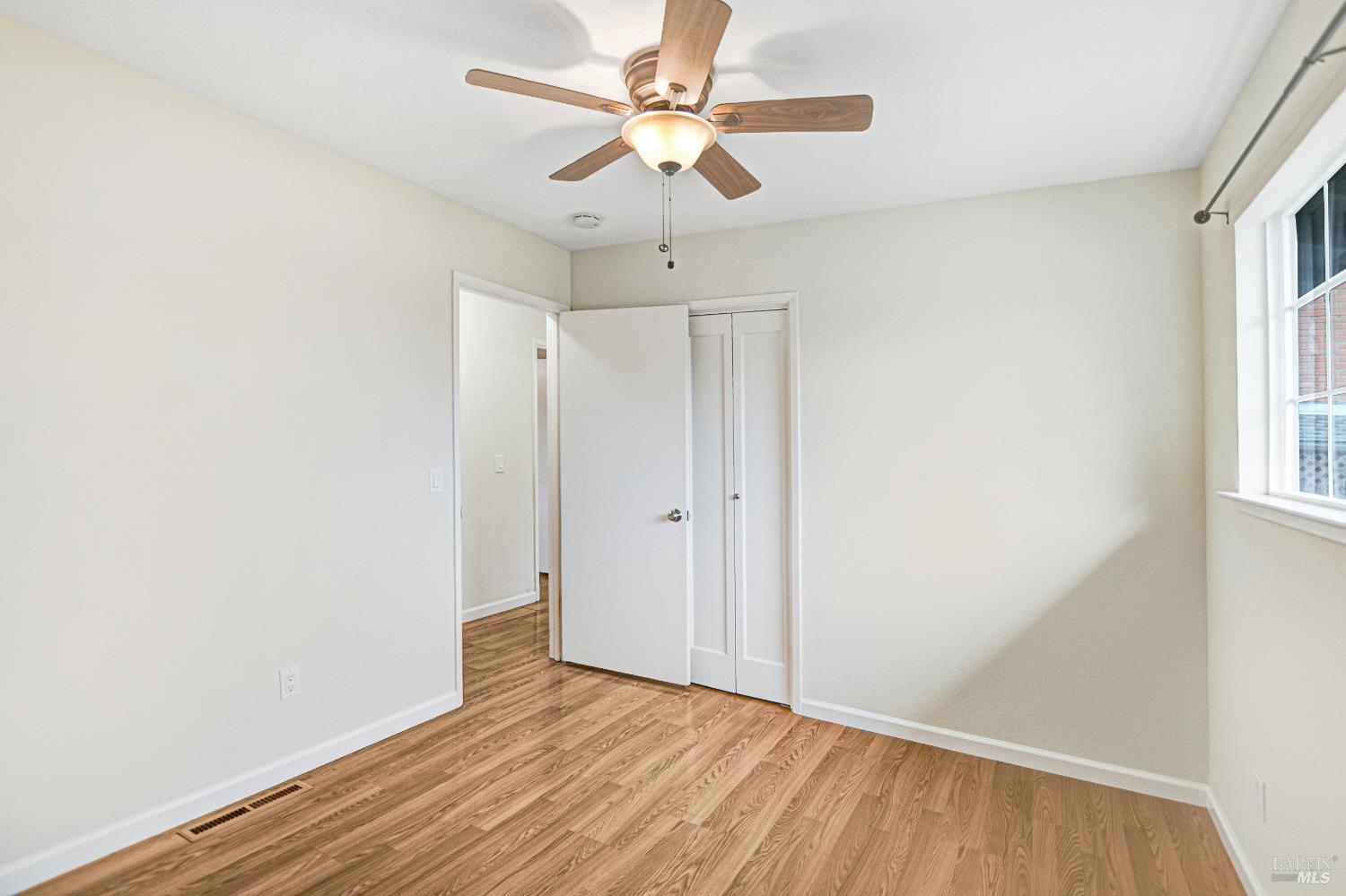 7257 Belita Avenue Rohnert Park, CA 94928 - Photo 30 of 37 a view of an empty room with a window and wooden floor