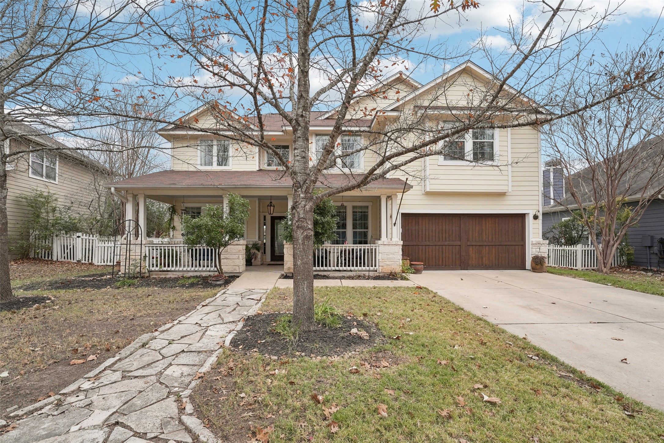 View of front of house featuring covered porch, concrete driveway, and an attached garage