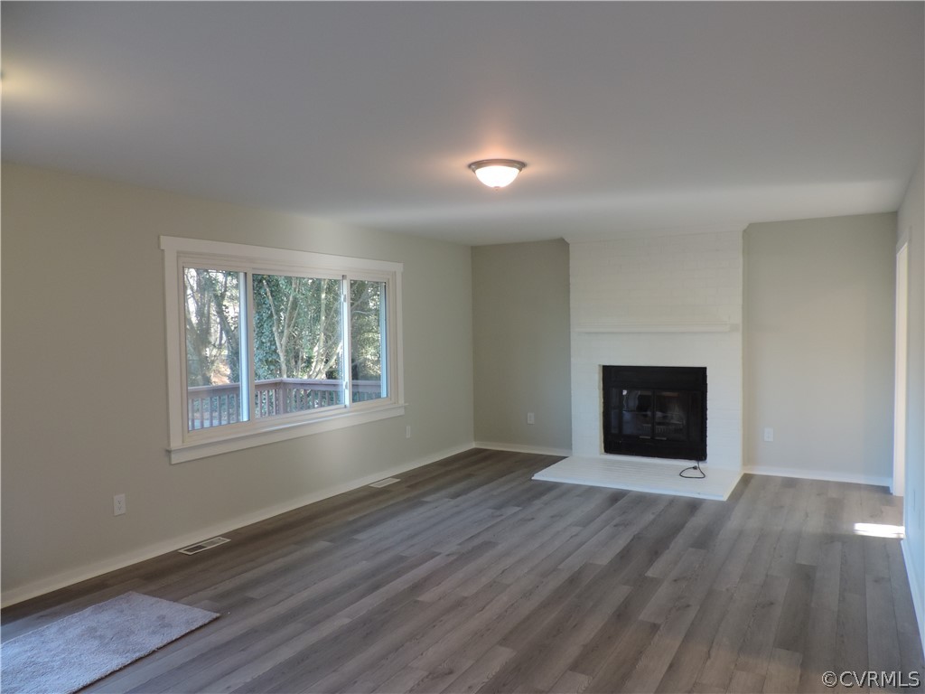 7825 Valencia Road Chesterfield, VA 23832 - Photo 5 of 26 an empty room with windows and fireplace
