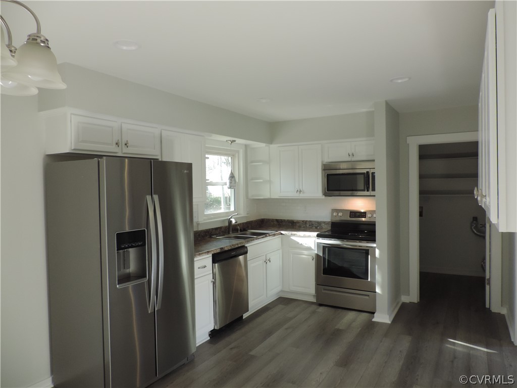7825 Valencia Road Chesterfield, VA 23832 - Photo 8 of 26 a kitchen with a refrigerator stove and sink