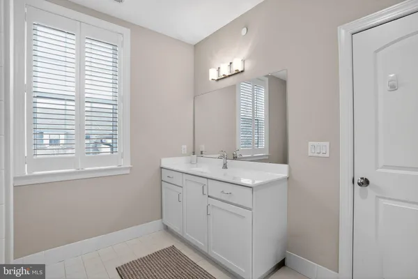 a bathroom with a double vanity sink toilet and mirror