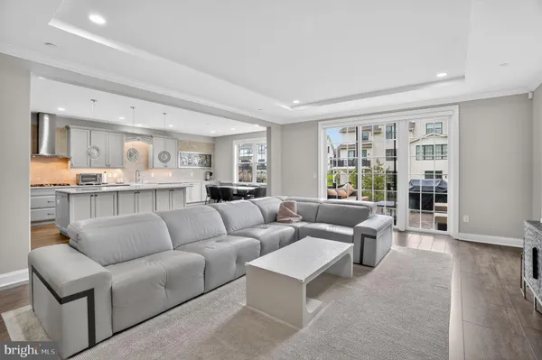 a large kitchen with stainless steel appliances granite countertop a large center island and a wooden floors