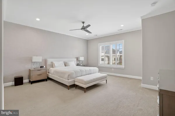 a spacious bedroom with a bed and a window