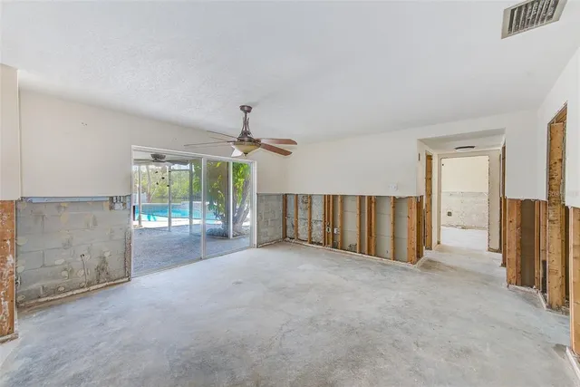 an empty room with windows and outdoor view