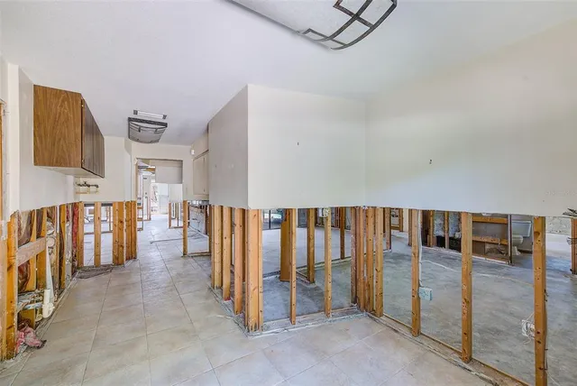a view of an empty room with a fireplace and a window