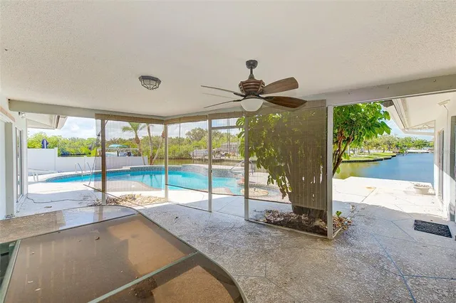 a view of a porch with furniture and floor to ceiling window