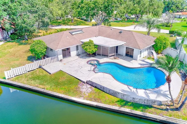 an aerial view of a house with a yard basket ball court and outdoor seating