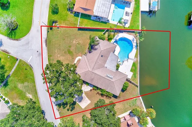 an aerial view of a house with a garden and swimming pool