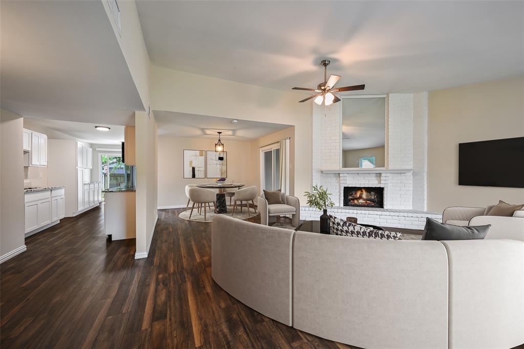 7318 Emory Oak Lane Dallas, TX 75249 - Photo 3 of 28 Spacious interior featuring wood-finish flooring, a white brick fireplace, and recessed lighting