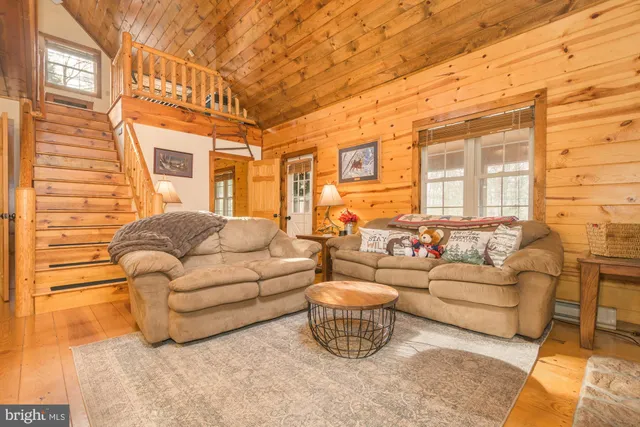 a living room with fireplace furniture and a flat screen tv