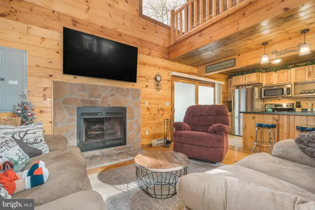 a kitchen with granite countertop stainless steel appliances a refrigerator a stove a sink and white cabinets with wooden floor