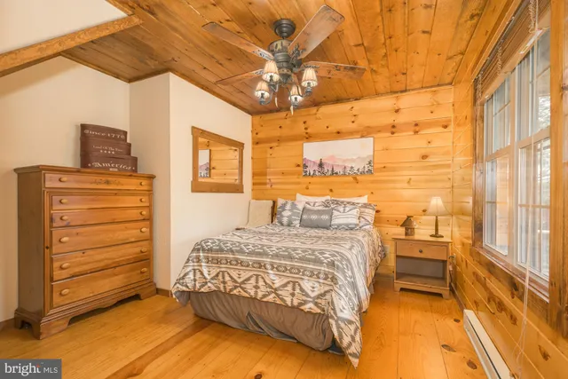 a bedroom with a bed chair and a large window