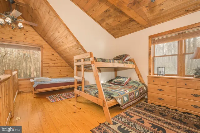 a bed room with a bed and a large window