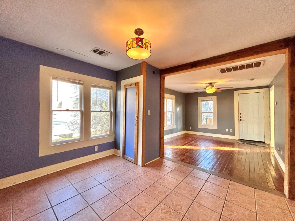 1112 West 3rd Street Taylor, TX 76574 - Photo 12 of 24 Spare room featuring light tile patterned floors and a ceiling fan