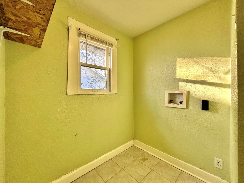 1112 West 3rd Street Taylor, TX 76574 - Photo 24 of 24 Laundry area with a textured wall, tile patterned flooring, and washer hookup