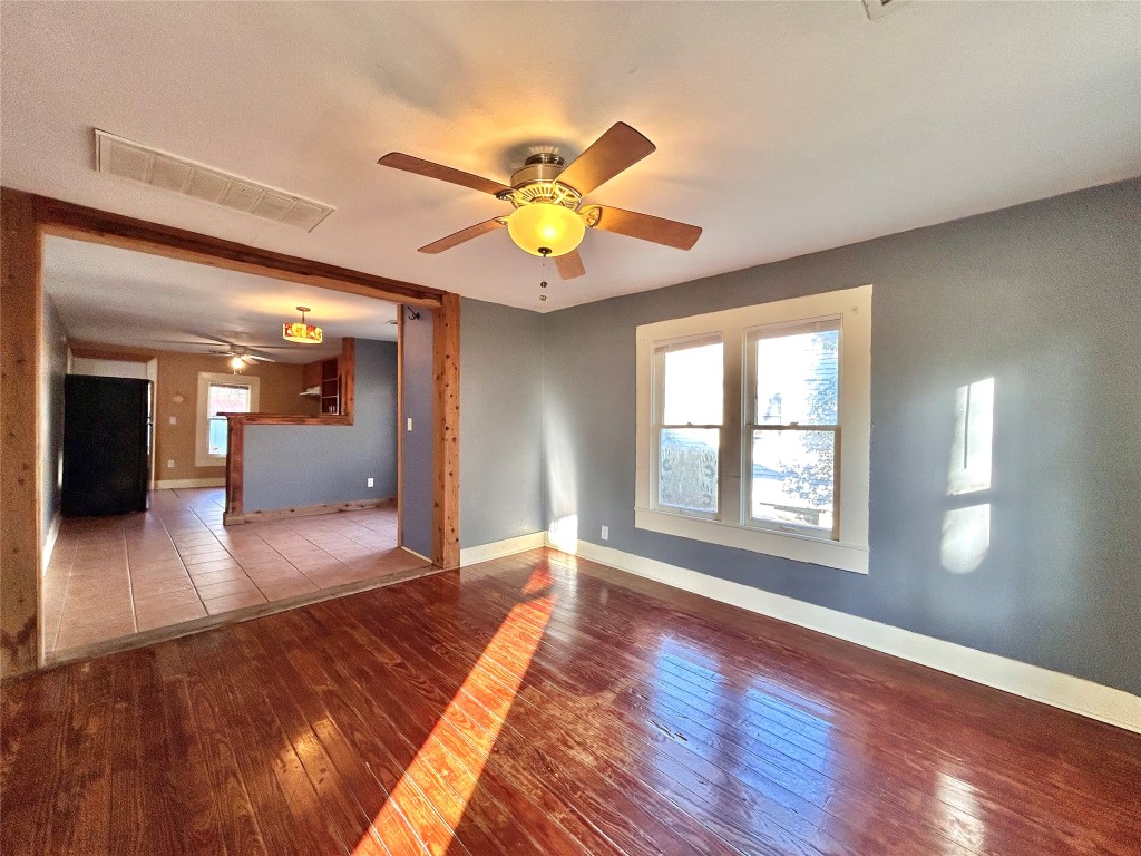 1112 West 3rd Street Taylor, TX 76574 - Photo 8 of 24 Spare room with wood-type flooring and ceiling fan